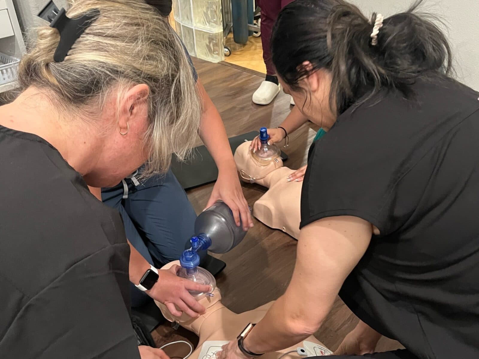Dental assisting students practicing clinical skills during certification training.