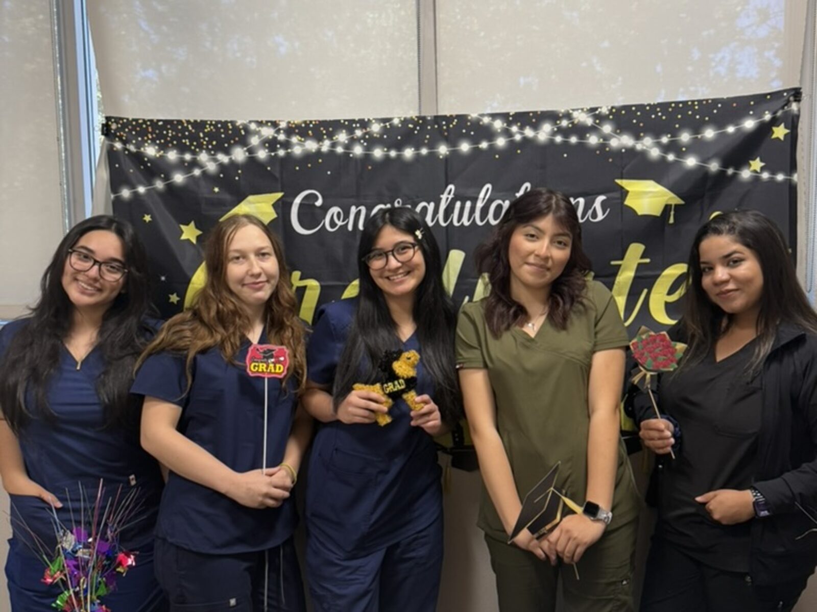 Recent Roseville Dental Academy students celebrating certificates indoors