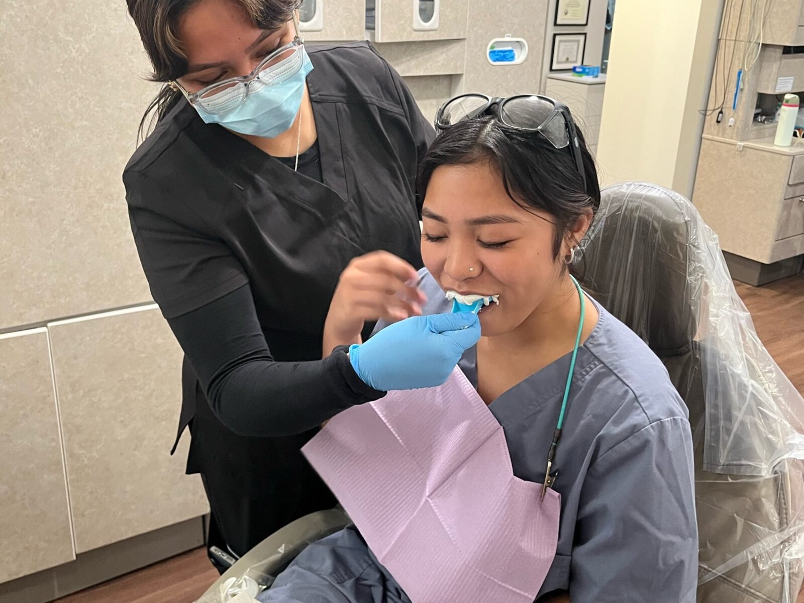 Students practicing chairside dental assisting skills